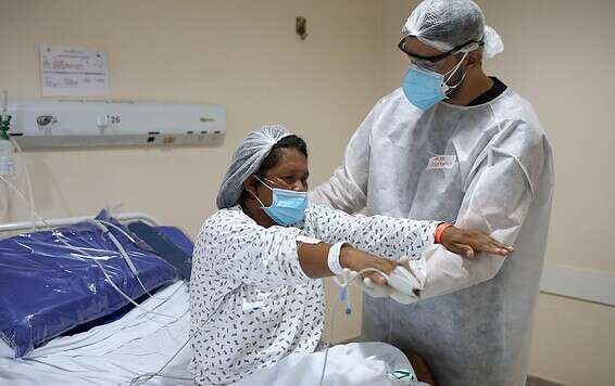 רופא מטפל בחולת קורונה בברזיל // צילום: רויטרס